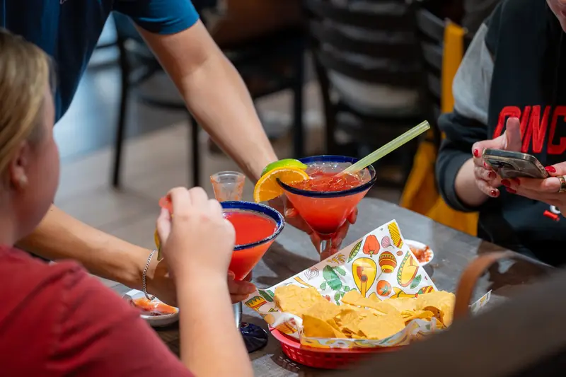 Margaritas toasting over chips