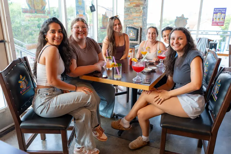 Friends at a window table in daylight