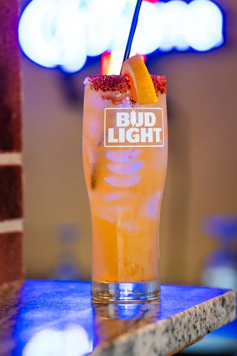 Beer cocktail under neon