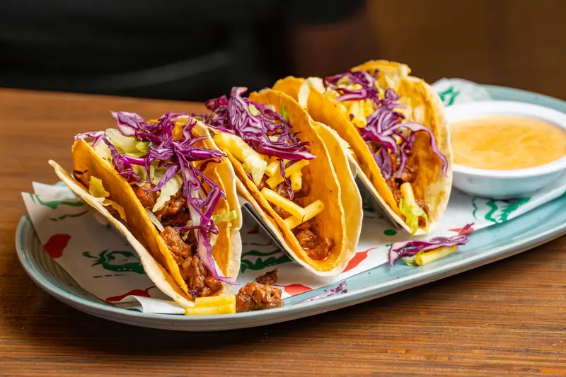 Crispy tacos with purple cabbage and queso